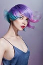 Portrait woman with bright colored flying hair, all shades of purple. Hair coloring, beautiful lips and makeup. Hair fluttering