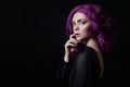 Portrait of a woman with bright colored flying hair, all shades of purple. Hair coloring, beautiful lips and makeup. Hair