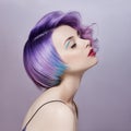 Portrait of a woman with bright colored flying hair, all shades of purple. Hair coloring, beautiful lips makeup. Hair fluttering Royalty Free Stock Photo