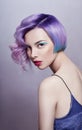 Portrait of a woman with bright colored flying hair, all shades of purple. Hair coloring, beautiful lips and makeup. Hair Royalty Free Stock Photo