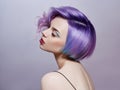 Portrait of a woman with bright colored flying hair, all shades of purple. Hair coloring, beautiful lips and makeup. Hair Royalty Free Stock Photo