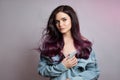 Portrait of a woman with bright colored flying hair, all shades of purple. Hair coloring, beautiful lips and makeup. Hair