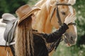 Portrait of woman in brown leather hat with a horse Royalty Free Stock Photo