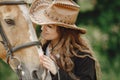 Portrait of woman in brown leather hat with a horse Royalty Free Stock Photo