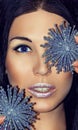 Portrait of woman brunette with Christmas decorations silver blue snowflakes. Fashion make-up. Royalty Free Stock Photo