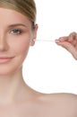 Portrait of woman brushing ear with cotton swab Royalty Free Stock Photo
