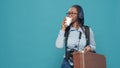 Portrait of woman carrying suitcase and backpack Royalty Free Stock Photo