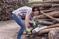 Portrait of a woman with a chainsaw