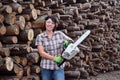 Portrait of a woman with a chainsaw