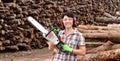 Portrait of a woman with a chainsaw