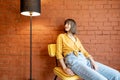 Portrait of a woman on chair on brick wall background Royalty Free Stock Photo