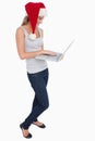 Portrait of a woman with a Christmas hat using a notebook Royalty Free Stock Photo