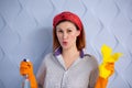 Portrait of woman with cleaning supplies on blue background Royalty Free Stock Photo