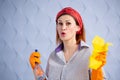 Portrait of woman with cleaning supplies on blue background Royalty Free Stock Photo