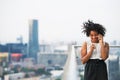 A portrait of a woman with coffee and smartphone standing on a terrace. Royalty Free Stock Photo