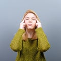 Portrait of woman concentrating against gray background