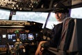 Portrait of woman copilot in uniform flying airplane jet