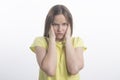 Portrait of woman covering ears with hands against white background Royalty Free Stock Photo