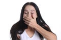 Portrait of woman covering hand over mouth on white background