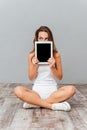 Portrait of a woman covering her face with tablet computer Royalty Free Stock Photo