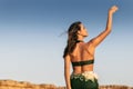 Portrait of Woman dancing on plain of the Namibe Desert. Africa. Angola