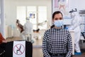Portrait of woman in dental office looking on camera wearing face mask