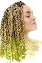 A portrait of a woman dissolving into an image of foliage. Double exposure Royalty Free Stock Photo