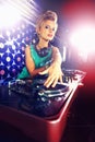 Portrait, woman dj, and headphones with vinyl in night club with mixing decks and lens flare. Female person, turntable Royalty Free Stock Photo