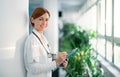 Portrait of woman doctor standing in hospital. Copy space. Royalty Free Stock Photo