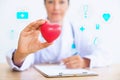 Portrait of woman doctor with holding red heart, Health care con Royalty Free Stock Photo