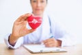 Portrait of woman doctor with holding red heart, Health care con