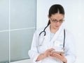 Portrait of woman doctor at hospital, writing on tablet computer Royalty Free Stock Photo