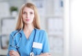 Portrait of woman doctor with stethoscope at hospital corridor Royalty Free Stock Photo