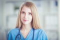 Portrait of woman doctor with stethoscope at hospital corridor Royalty Free Stock Photo