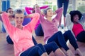 Portrait of woman doing sit ups with friends Royalty Free Stock Photo