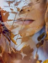 Portrait of a woman with a double exposure, the girl and the blurred nature of the photo is not in focus. The leaves on the woman. Royalty Free Stock Photo