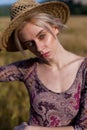 Portrait of a farmer woman in a dress in a field of rye harvest Royalty Free Stock Photo