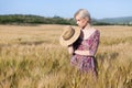 Portrait of a farmer woman in a dress in a field of rye harvest Royalty Free Stock Photo