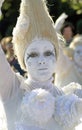 Portrait of a woman dressed in all white, her face is painted in white as well. Royalty Free Stock Photo