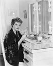 Portrait of woman at dressing table Royalty Free Stock Photo