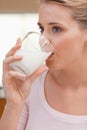 Portrait of a woman drinking a glass of milk Royalty Free Stock Photo