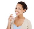 Portrait, woman and drinking water in studio for healthy nutrition, diet and detox on white background. Happy model with Royalty Free Stock Photo