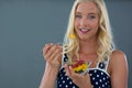 Portrait of woman eating fruit salad in bowl Royalty Free Stock Photo