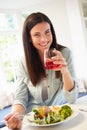 Portrait Of Woman Eating Healthy Meal In Kitchen Royalty Free Stock Photo