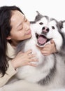 Portrait of woman embracing her dog, studio shot Royalty Free Stock Photo