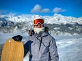 PORTRAIT: Woman is excited to be on snowboarding trip in Slovenian mountains Royalty Free Stock Photo