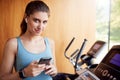 Portrait Of Woman Exercising Wearing Wireless Earphones And Smart Watch Checking Mobile Phone Royalty Free Stock Photo