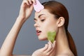 portrait woman facial scraper skin care posing isolated background