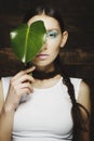 Portrait of woman with fashion make up with blue eye and leaf on Royalty Free Stock Photo