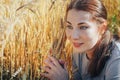 Portrait of woman on a field full of yellow ears Royalty Free Stock Photo